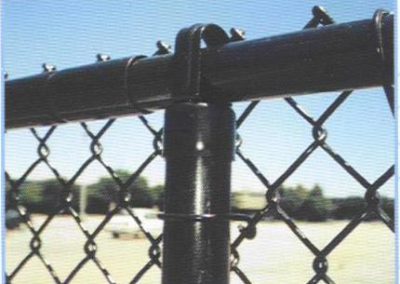 Black powder coated chain link fence framework with black vinyl clad mesh. Mesh is referred to as 'fabric' in the fence industry!